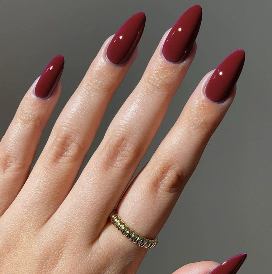 Long almond press-on nails in glossy burgundy