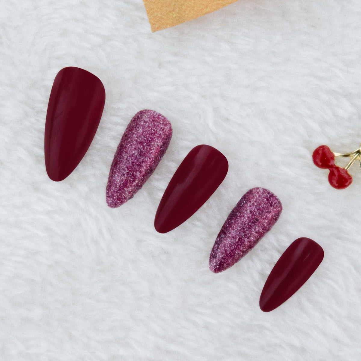 Long almond press-on nails in wine red glitter