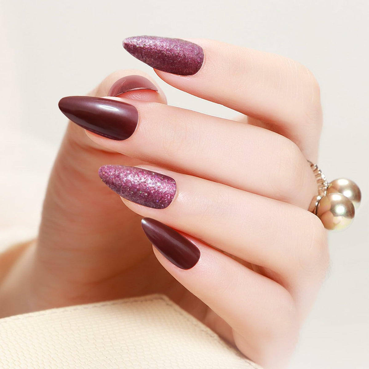 Long almond press-on nails in wine red glitter